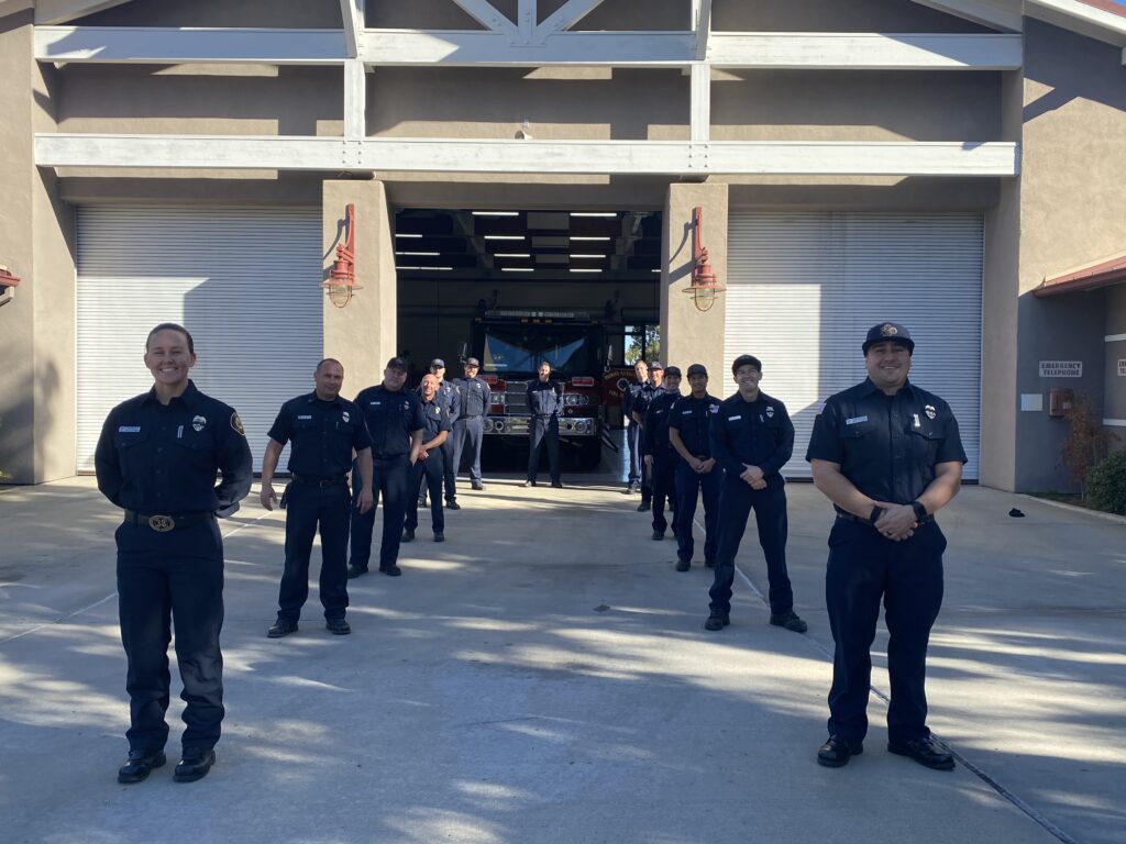 The personnel of Bonita-Sunnyside Fire Protection District stand in ranks in front of the station